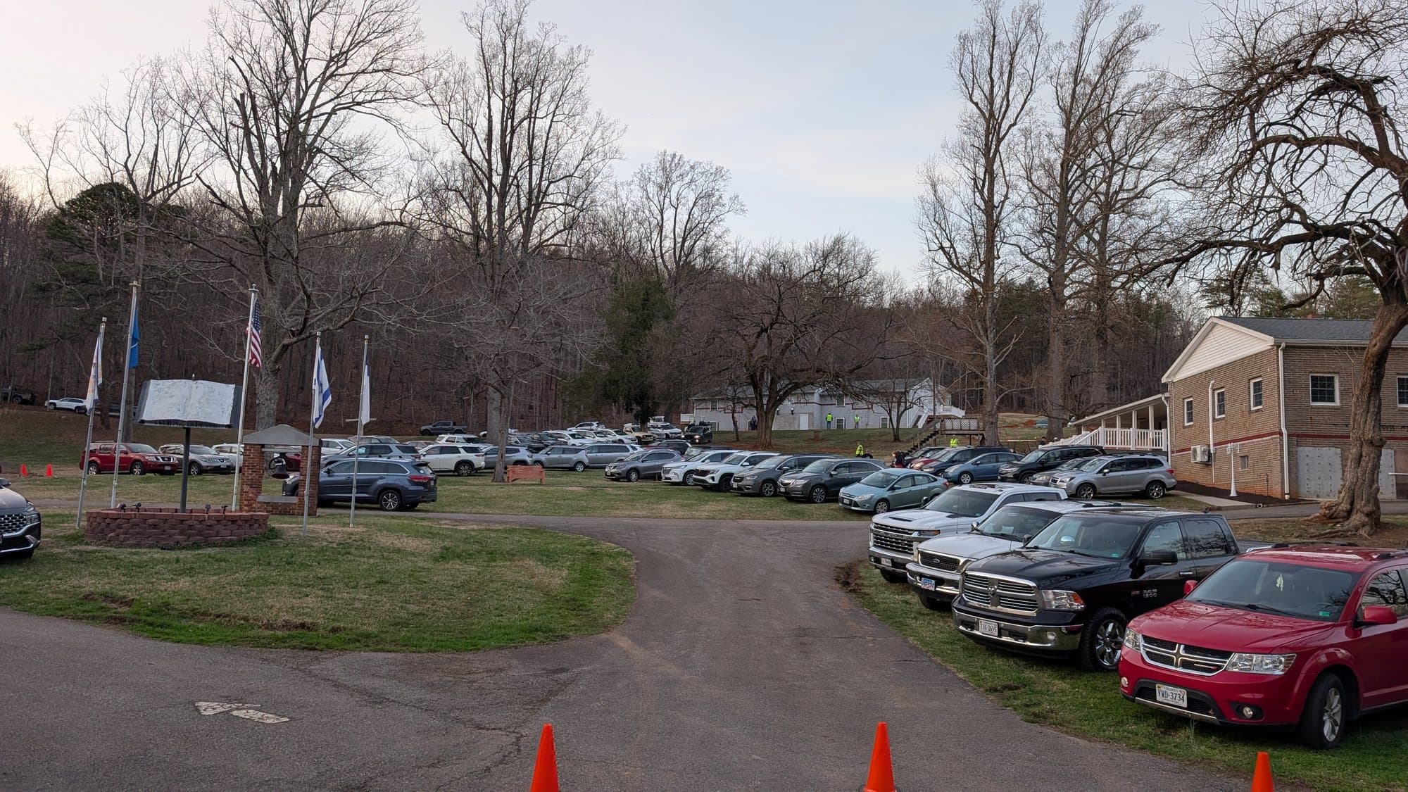 The front lot at Springs of Life Camp with flags flying at dusk