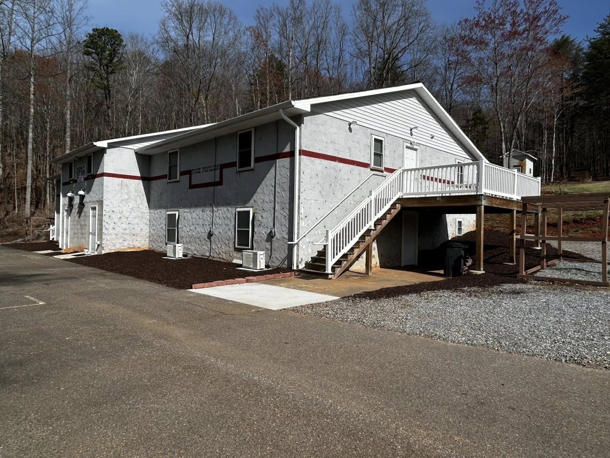Two-story lodge building at Springs of Life Camp with an outside stairway